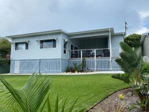 a blue house with a lawn in front of it at Seamist @ Scotts Head in Scotts Head