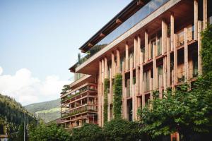 a building with plants on the side of it at Small Luxury Hotel of the World - DasPosthotel in Zell am Ziller