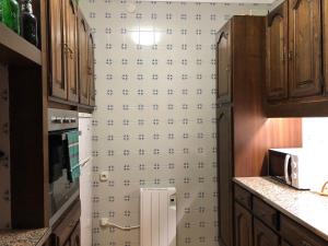 a kitchen with a refrigerator with a wallpaper at EVA & TRAVEL - Triplex La Cavallada in Prades