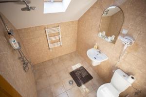 a bathroom with a sink and a toilet and a mirror at DUNESDORFER PENSION in Daneş +32 photos