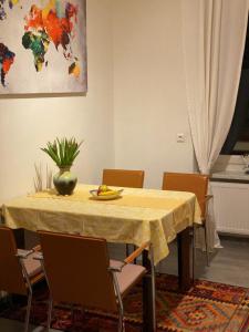 a dining room table with a yellow table cloth and chairs at Villa PetraBUNT in Villach +34 photos