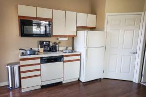 a kitchen with white appliances and a white refrigerator at Sleepover 1BD 1BA Downtown Wichita Apartments in Wichita