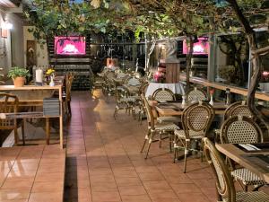 an empty restaurant with tables and chairs and trees at Pension Bella Vista - Winzerhof Golk in Meißen