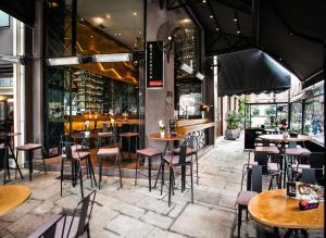 a restaurant with tables and chairs and a bar at Ladadika Design, Philian Hotels and Resorts in Thessaloniki