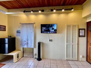 a room with a flat screen tv on the wall at Coffee Garden in Captain Cook