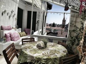 a room with a table and a couch on a balcony at RaMaya, casa d'artista in Biella +21 photos