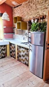a kitchen with a stainless steel refrigerator in a room at Casa della Casa in San Severino Marche