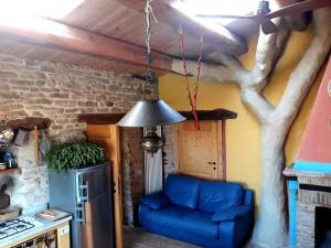 a living room with a blue couch and a tree at Casa della Casa in San Severino Marche +98 photos