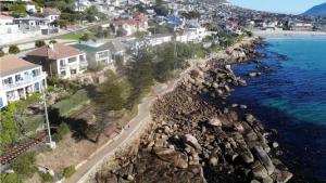 an aerial view of a beach with houses and the ocean at Paradise On the Bay in Fish Hoek