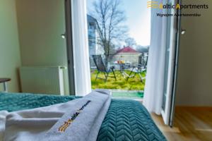 Łóżko lub łóżka w pokoju w obiekcie Baltic Apartments - Apartamenty Korony Piastów