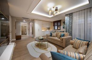 a living room with a couch and a table at Elysium Green Suites in Antalya