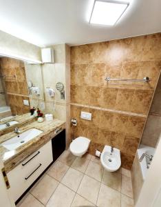 a bathroom with a toilet and a sink at Apartment Bonaca in Portorož