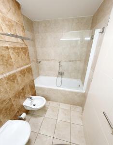 a bathroom with a sink and a toilet and a tub at Apartment Bonaca in Portorož +13 photos