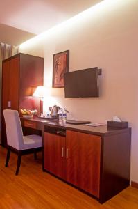a room with a desk with a chair and a monitor at Park Avenue Hotel Nungambakkam in Chennai