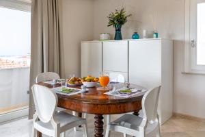 a dining room table with a bowl of fruit on it at Viareggio Suite - Sea view apartment in Viareggio