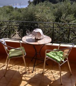 a table and two chairs on a balcony at Paradise Studios in Paleokastritsa