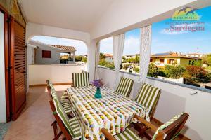 a table and chairs on the balcony of a house at Residence Tanaunella in Budoni
