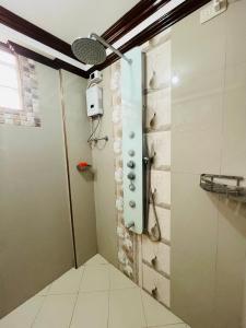 a shower stall in a bathroom with a shower head at RESTHOUSE fully airconditioned w/ Private Parking in Tuguegarao City +44 photos