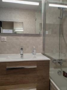 a bathroom with a sink and a shower and a tub at l’Écrin du Verger in Baldersheim +20 photos