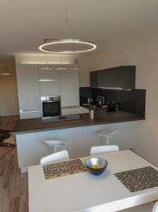 a kitchen with a table with chairs and a bowl on it at l’Écrin du Verger in Baldersheim