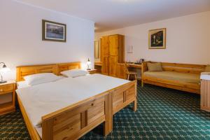 a hotel room with two beds and a table at Penzion Kaps in Bled