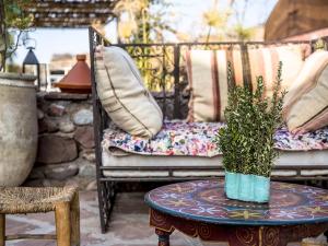 a table with a potted plant on a patio at Dar Tafantant in Marrakech