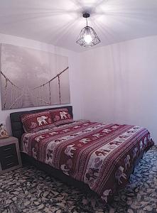 a bedroom with a bed with a bridge on the wall at Apartment PaCa Javea in Jávea