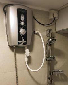 a water dispenser on the wall of a bathroom at Manjula Luxury Apartment in Negombo