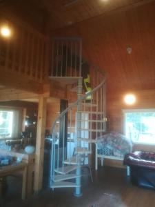 a room with a spiral staircase in a cabin at Hevosniemi in Korppoo