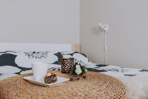 a table with a tray of food and coffee on a bed at Kevade Guesthouse with Sauna in Kuressaare