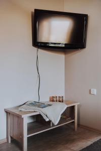 a flat screen tv hanging from a wall at Kevade Guesthouse with Sauna in Kuressaare