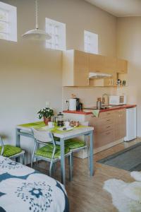a kitchen with a table and chairs in a room at Kevade Guesthouse with Sauna in Kuressaare