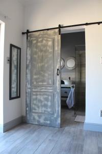 a sliding door in a room with a bathroom at 19 on Micro Avenue in Strand