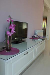 a table with a vase with flowers on it at Apartment Siesta in Cavtat +25 photos