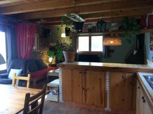 a kitchen and living room with a table and a couch at Casa de campo Laldeta in Puertomingalvo