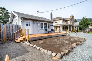 a house with a large deck in front of it at Cottage by the Sea (MCA #1213) in Manzanita