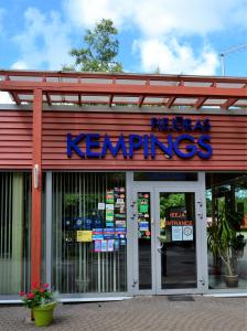 a store with a sign on the front of it at Piejūras Kempings in Ventspils