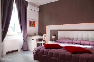 a bedroom with a bed and a desk and a window at B&B Villa Diana in Sulmona
