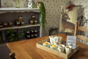 a wooden table with a tray of jam and a box of coffee at B&B 't Inj in Horn