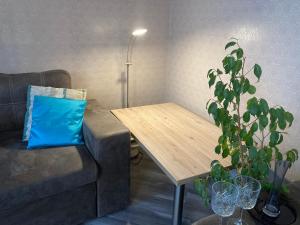 a living room with a couch and a wooden table at Apartment Sobornaya 54 in Vinnytsya