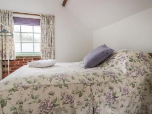 a bed with two pillows on it in a bedroom at Ostlers in Mitcheldean