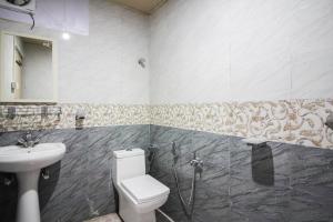 a bathroom with a toilet and a sink at Glamwood Resort Dhanaulti, Ranked 1 in Dhanaulti in Dhanaulti +33 photos
