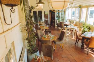 a restaurant with tables and chairs and tables and windows at The Gin Trap Inn in Ringstead