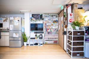 a kitchen with two refrigerators and a refrigerator at Peace House Sachi in Osaka