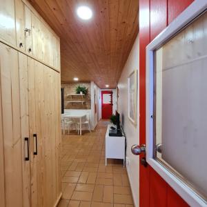 a hallway with wooden walls and a red door at Casas Alba Odeceixe in Odeceixe