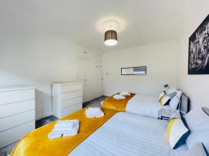 two beds in a bedroom with white walls at Cardonald Central in Glasgow