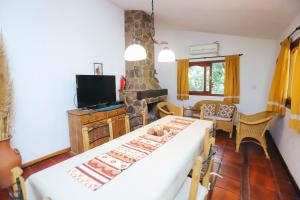 a living room with a table and a fireplace at Cabaña Modestita - FINCA PUDUAM in Villa General Belgrano