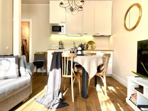 a kitchen and living room with a table and a couch at Cesis Boulevard Apartments in Cēsis
