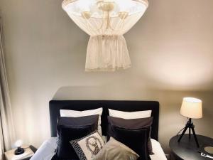 a bedroom with a bed with a dress on the wall at Cesis Boulevard Apartments in Cēsis