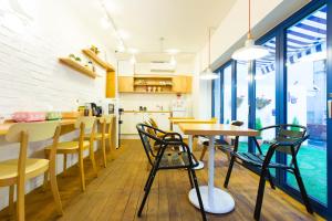 a kitchen and dining room with wooden tables and chairs at Hotel Gaon Seoul Dongdaemun in Seoul